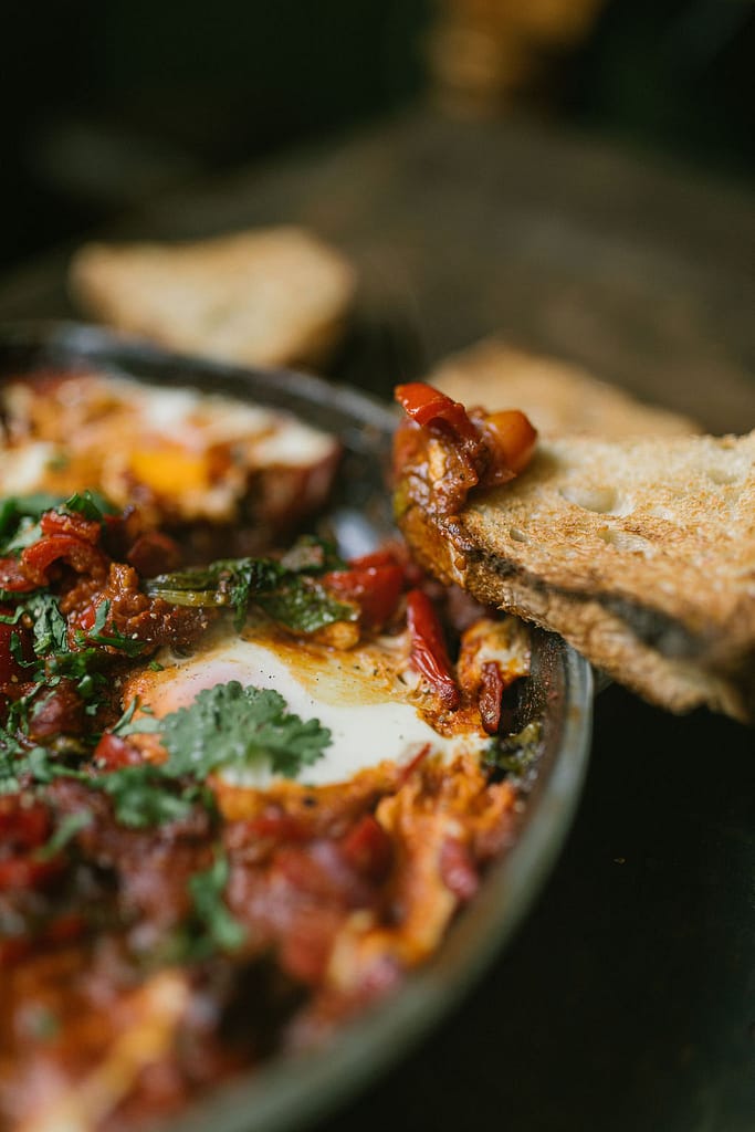 Shakshuka a tomato based dish with eggs and sourdough bread. 