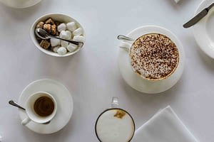 flatlay of coffees and white table cloth nat Aubry photography