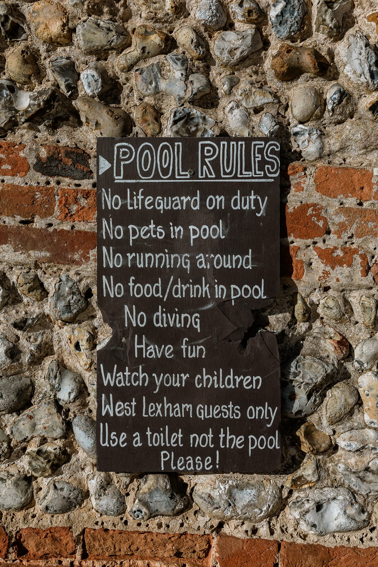 Pool_rules_written_on_a_black_slate_board