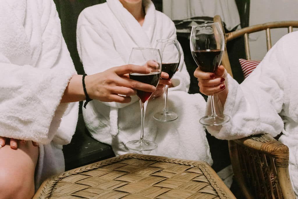 hands_cheering_wine_glasses_together