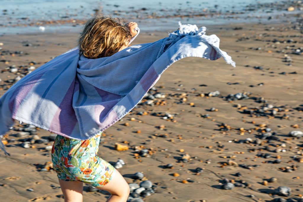 girl_holding_beach_towel_superhero