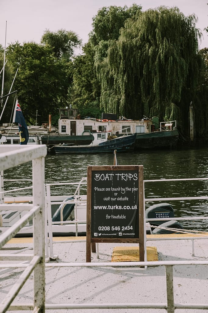 Blackboard with Boat trips by the river