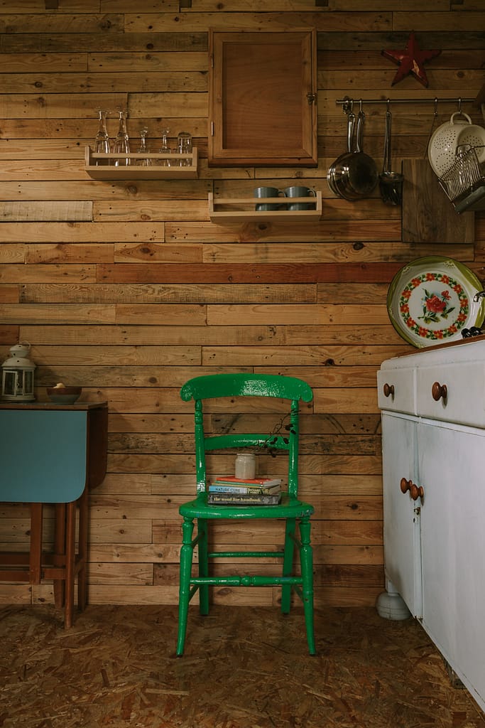 green_chair_rustic_cabin_kitchen