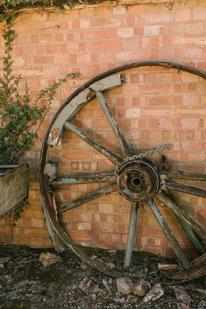Cart wheel against a brick wall