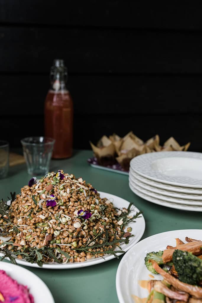 Spelt Salad and vegan dishes on a zinc table prepared by Chef Naturelle