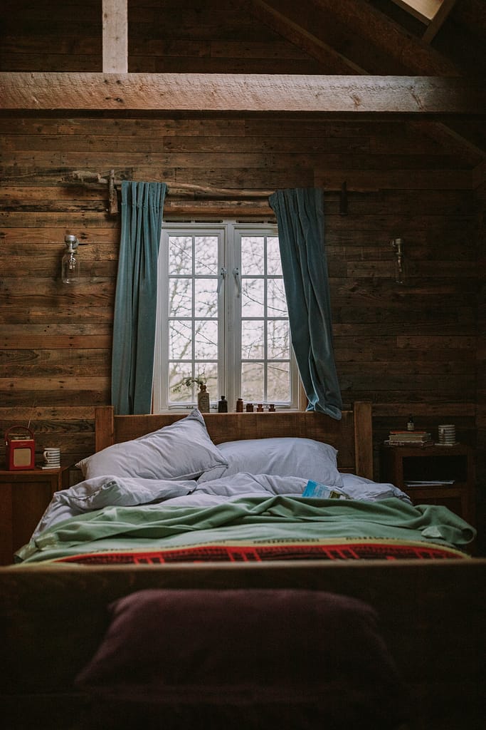 unmade_bed_cabin_interiors_wood