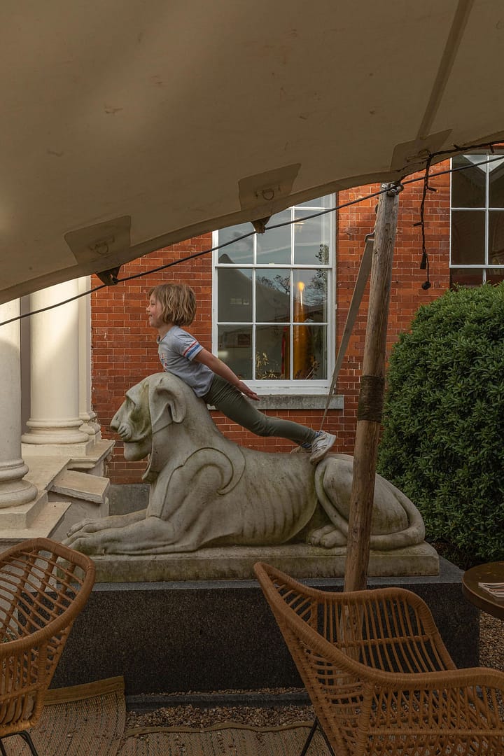 girl on lion sculpture outside