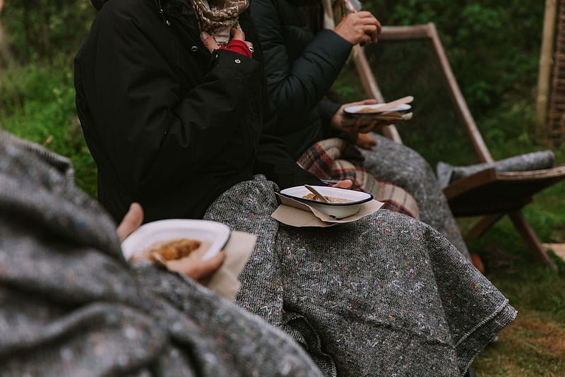 Outdoor porridge breakfast under blankets